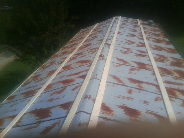 Rusted metal roof panels with new wood purlins before replacement — Storm Damage Roof Repair in Lonsdale by Roofing Brothers